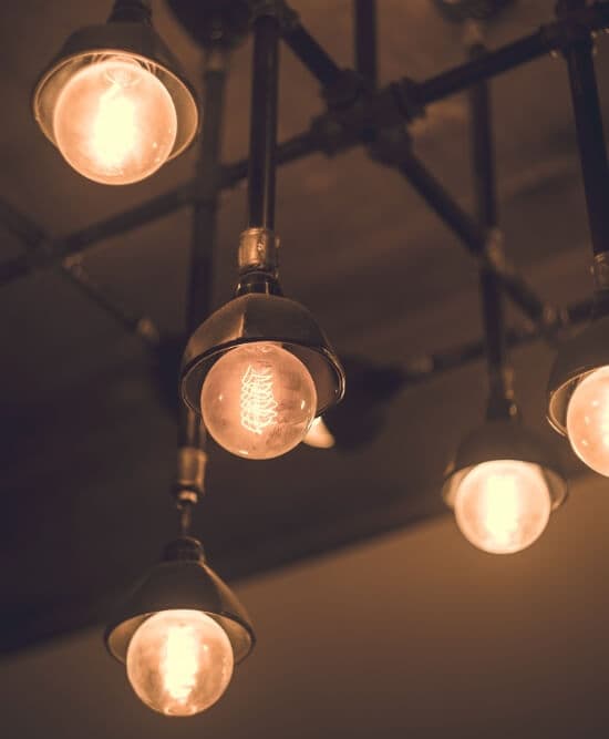 Rustic pendant lights with low lit incandescent bulbs hanging from ceiling