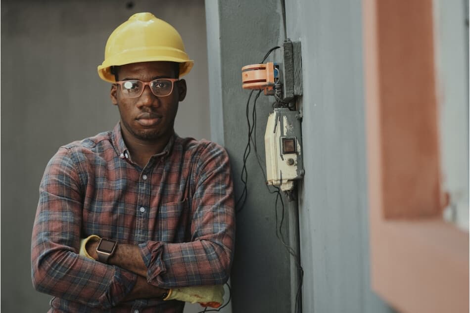 Electrician poses next to completed inspection job