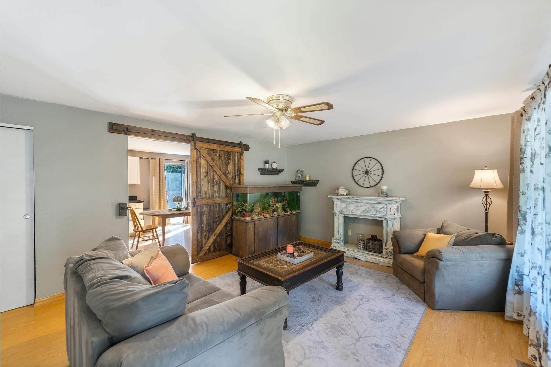 Finished living room with overhead fan lighting